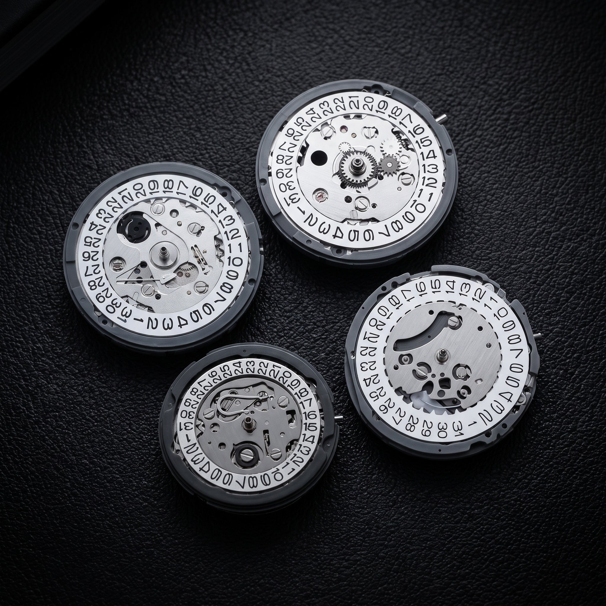 The four Japanese movements used by Chrono Mod: NH35 and NH34 GMT automatics, NH05 automatic and VK63 meca-quartz, on black leather