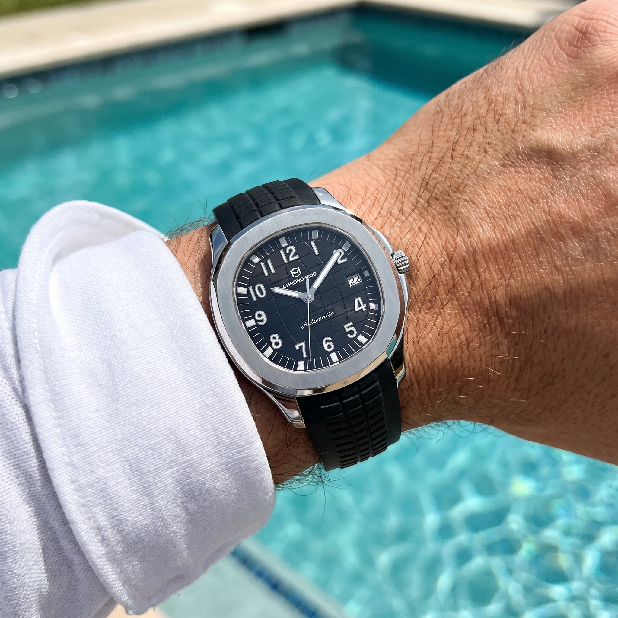 Chrono Mod Odyssey sports watch worn on the wrist by the pool, natural light