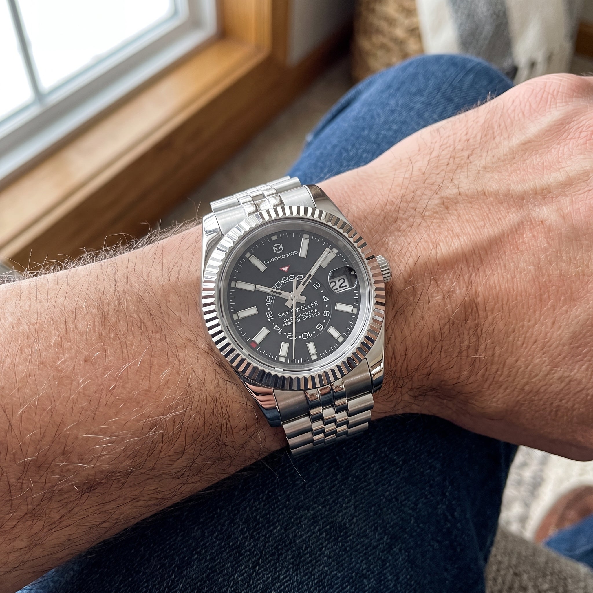 Chrono Mod Sky-Dweller style watch worn on the wrist, natural light