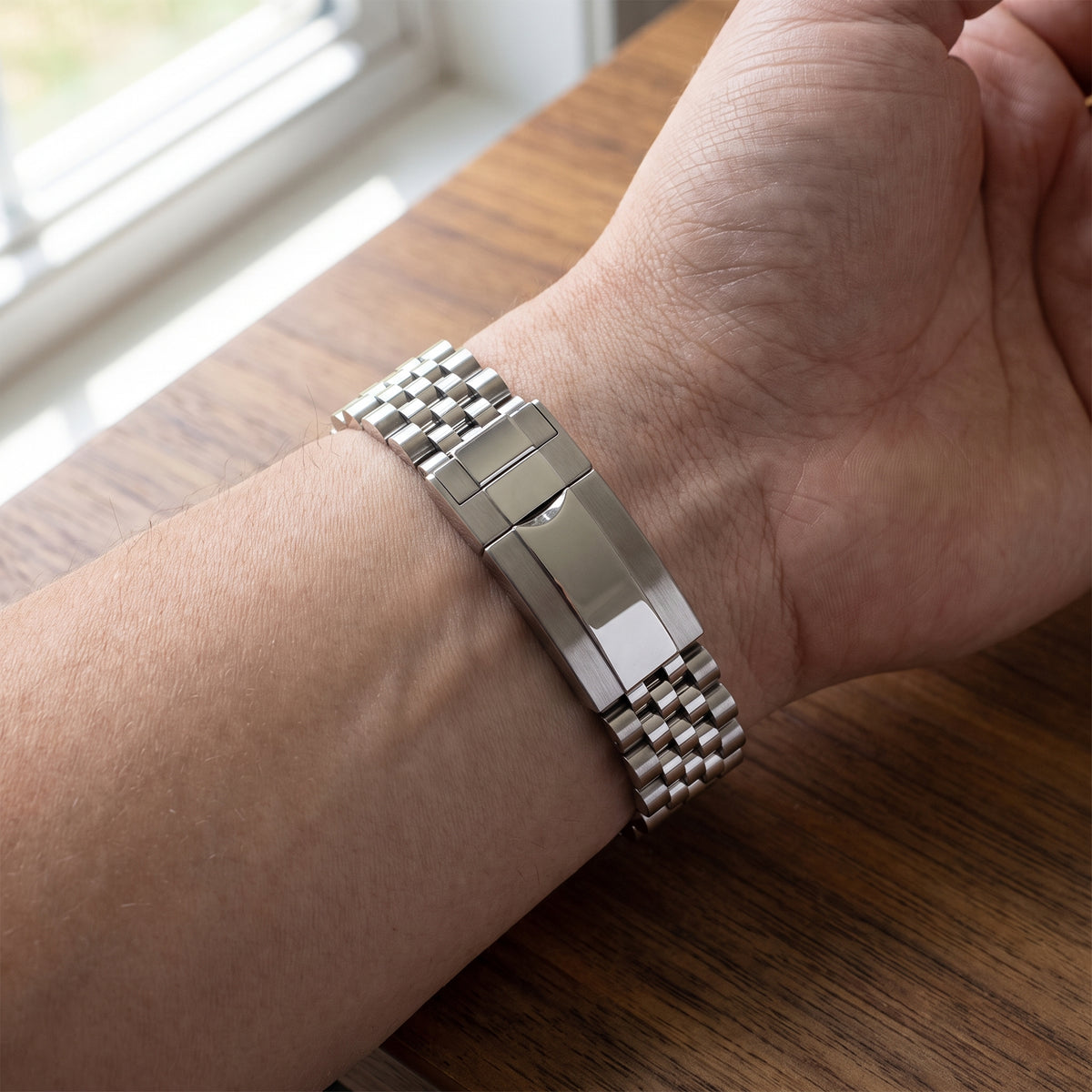 Chrono Mod Jubilee steel bracelet with hidden clasp worn on the wrist, natural light