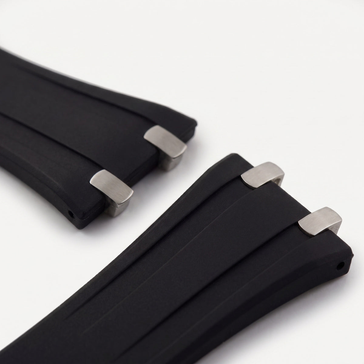 Close-up of the forked strap ends with polished steel tips that sit flush against the Apex case