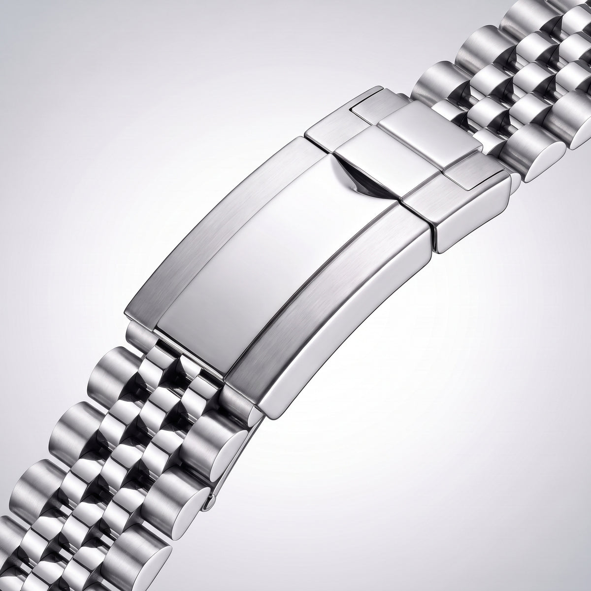 Close-up of the Jubilee folding clasp: polished cover plate, brushed flanks and flip-lock safety catch
