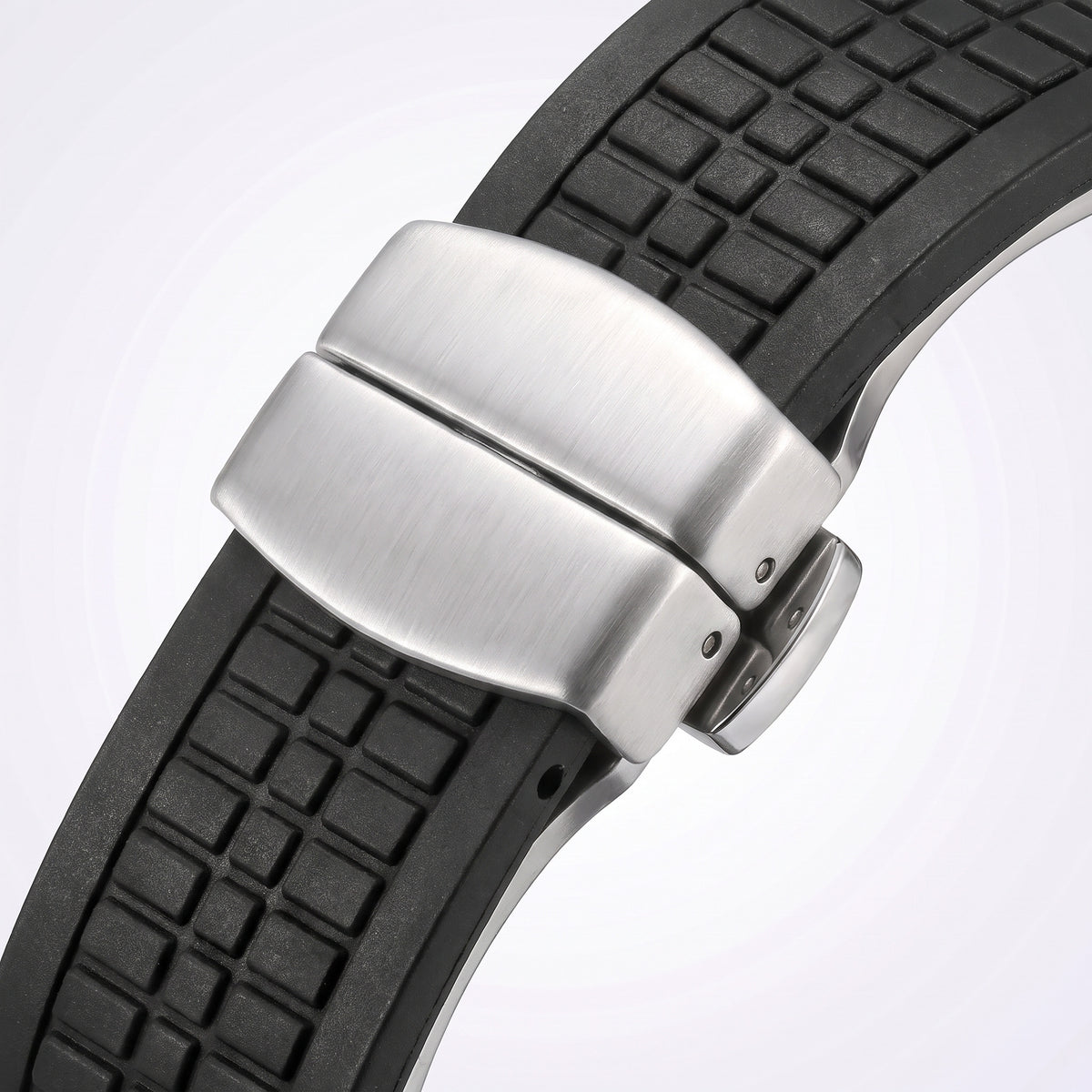 Brushed stainless steel fold-over deployant clasp of the Odyssey 21 mm rubber strap, shown close up